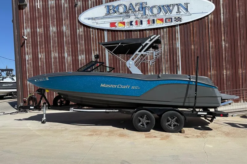 The Image of 2018 MasterCraft NXT22 boat on trailer at Boat Town dealership. - 0