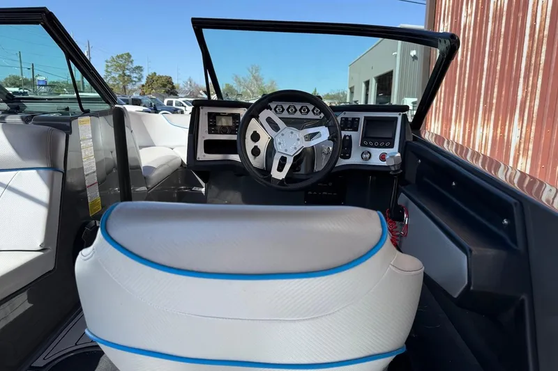 Slide: The Image of Interior of 2018 MasterCraft NXT22 boat with steering wheel and dashboard controls. - 10