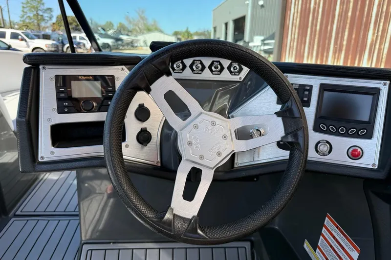 Slide: The Image of 2018 MasterCraft NXT22 boat dashboard with steering wheel and control panels. - 11