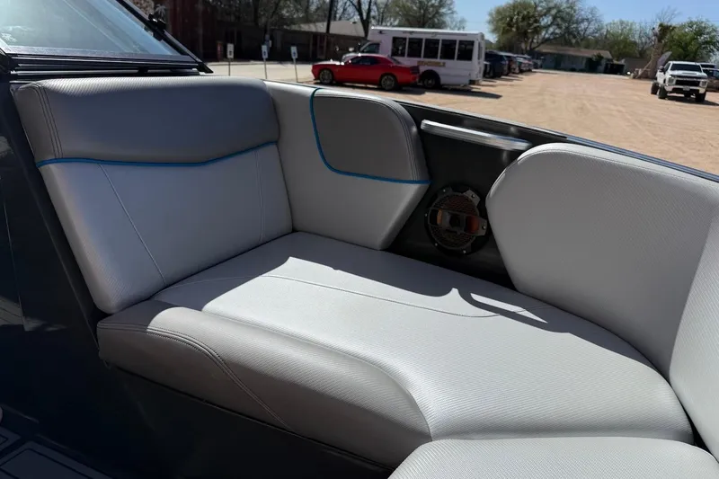 Slide: The Image of 2018 MasterCraft NXT22 boat interior with gray seating and speaker detail. - 17