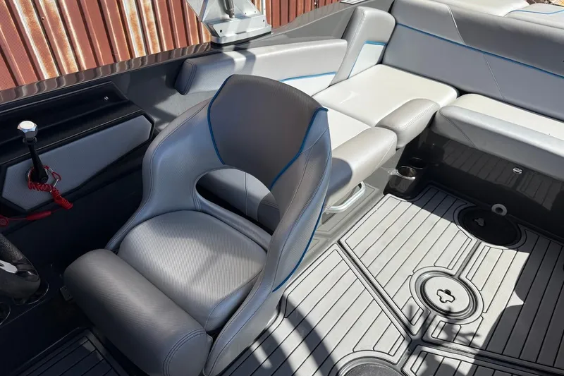 Slide: The Image of 2018 MasterCraft NXT22 boat interior with gray seating and modern design. - 19