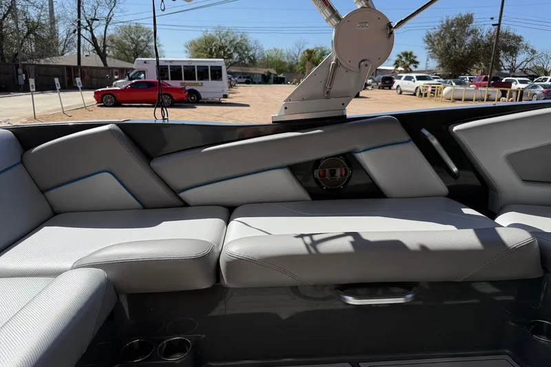 Slide: The Image of Interior seating of a 2018 MasterCraft NXT22 boat with gray upholstery. - 7