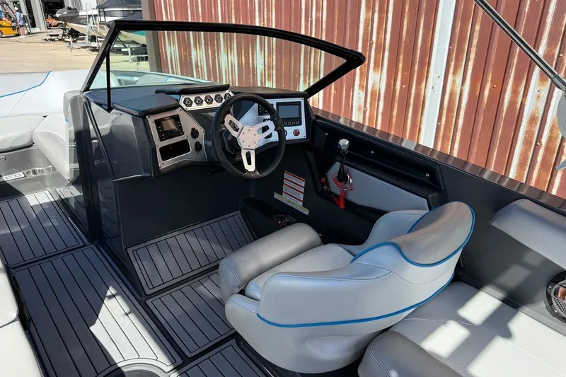 Slide: The Image of 2018 MasterCraft NXT22 boat interior with steering wheel and dashboard controls. - 9