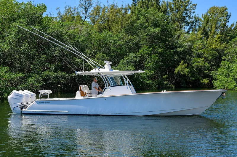 The Image of 2025 Valhalla V-37 boat on calm water, surrounded by lush greenery. - 0