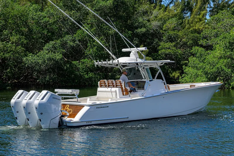 Slide: The Image of 2025 Valhalla V-37 boat cruising on a serene waterway with lush greenery. - 10