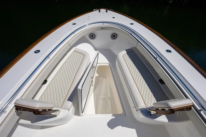Slide: The Image of 2025 Valhalla V-37 boat interior with cushioned seating and storage compartment. - 19