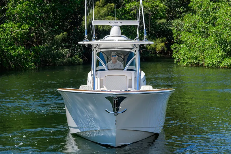 Slide: The Image of 2025 Valhalla V-37 boat cruising on a serene waterway surrounded by lush greenery. - 3