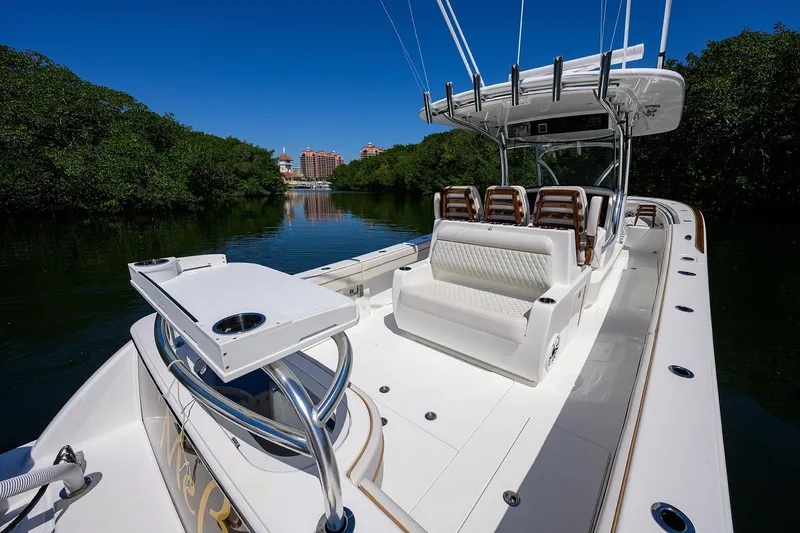 Slide: The Image of 2025 Valhalla V-37 boat cruising on a serene river with lush greenery. - 34