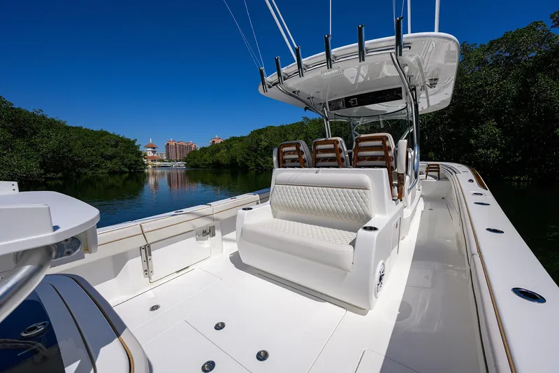 Slide: The Image of 2025 Valhalla V-37 boat interior with seating, surrounded by lush greenery and clear blue sky. - 35