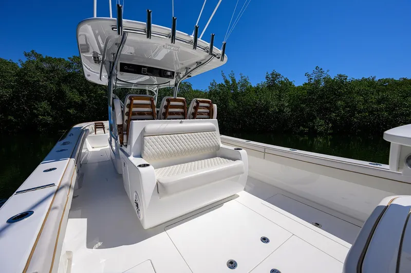 Slide: The Image of 2025 Valhalla V-37 boat interior with seating, sleek design, and lush greenery backdrop. - 39