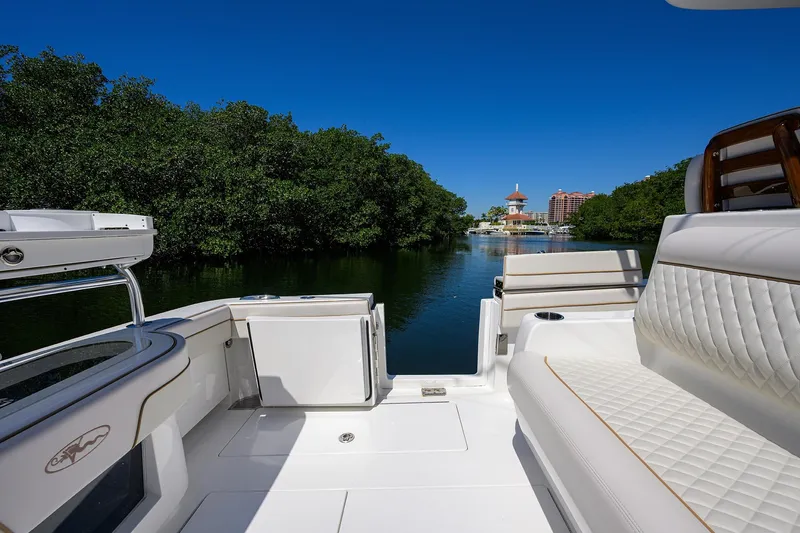 Slide: The Image of Valhalla Boatworks V-37 2025 on calm water with lush greenery. - 40