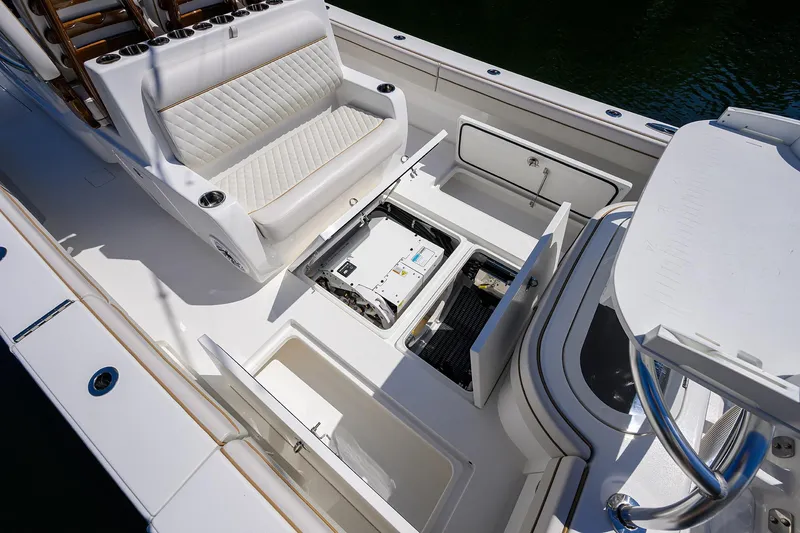 Slide: The Image of 2025 Valhalla V-37 boat interior with open storage compartments and cushioned seating. - 45