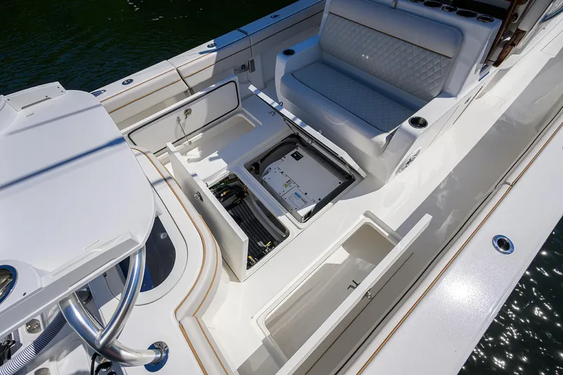 Slide: The Image of 2025 Valhalla V-37 boat interior with open storage compartments and cushioned seating. - 46
