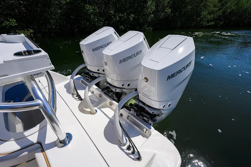 Slide: The Image of Triple Mercury outboard engines on 2025 Valhalla V-37 boat, docked on calm water. - 49