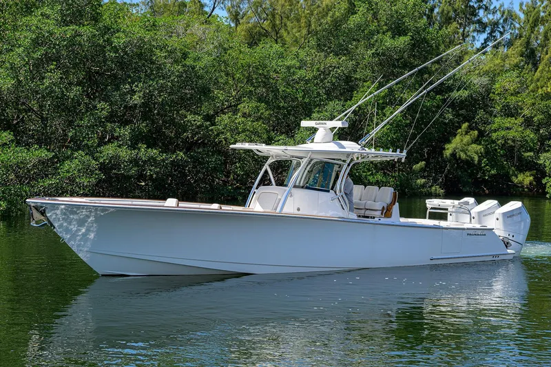 Slide: The Image of 2025 Valhalla V-37 boat on calm water, surrounded by lush greenery. - 5