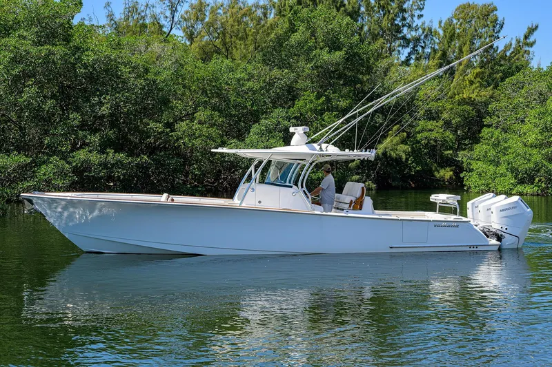 Slide: The Image of 2025 Valhalla V-37 boat cruising on a calm river surrounded by lush greenery. - 6