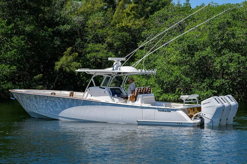 Slide: The Image of 2025 Valhalla V-37 boat with triple Mercury engines on a calm waterway. - 7