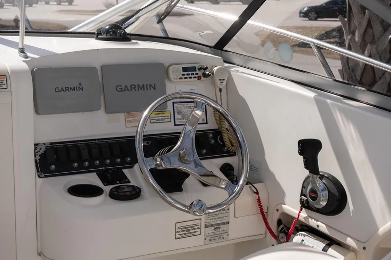 Slide: The Image of 2005 Boston Whaler 235 Conquest helm with Garmin navigation and control panel. - 11