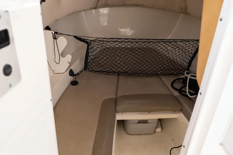 Slide: The Image of Interior cabin of 2005 Boston Whaler 235 Conquest boat with storage net and seating. - 12