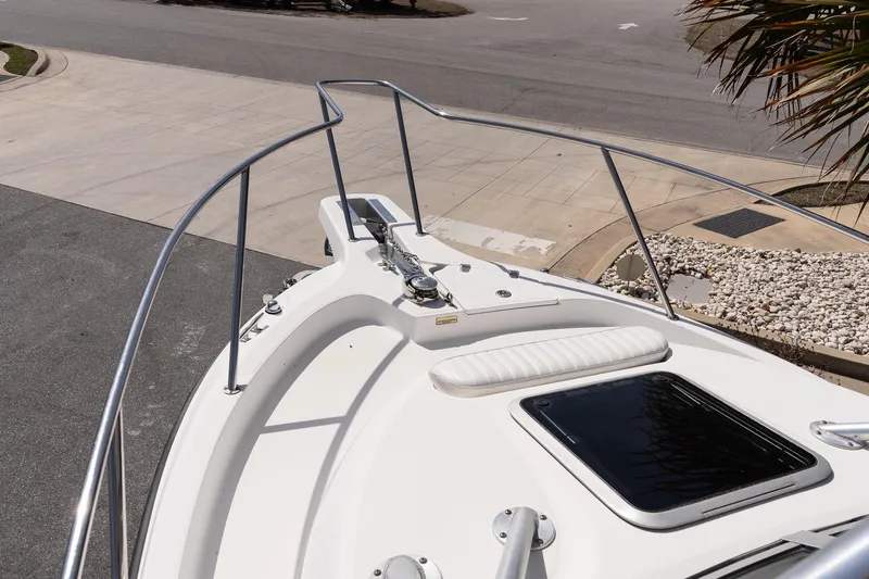 Slide: The Image of Bow view of 2005 Boston Whaler 235 Conquest boat with railing and hatch. - 16