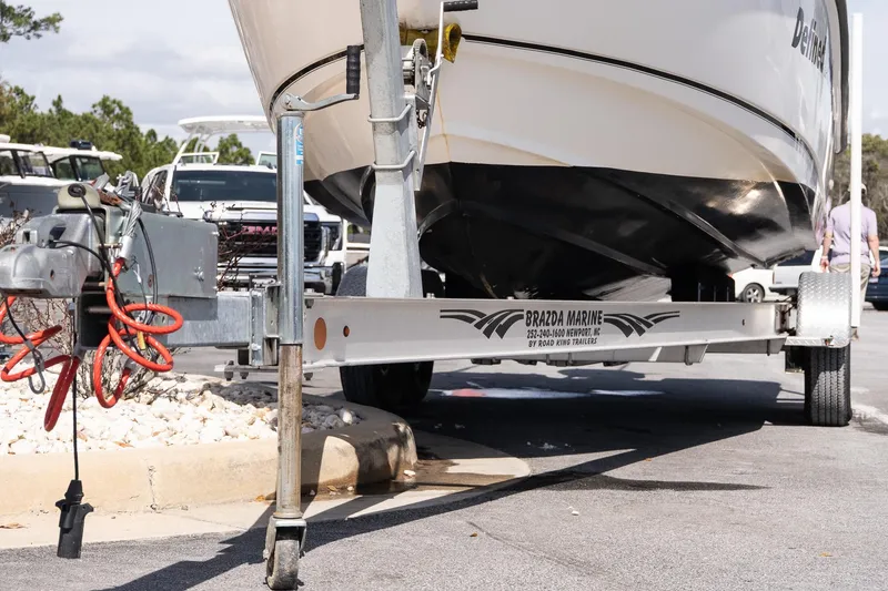 Slide: The Image of 2005 Boston Whaler 235 Conquest boat on trailer at marina parking lot. - 20