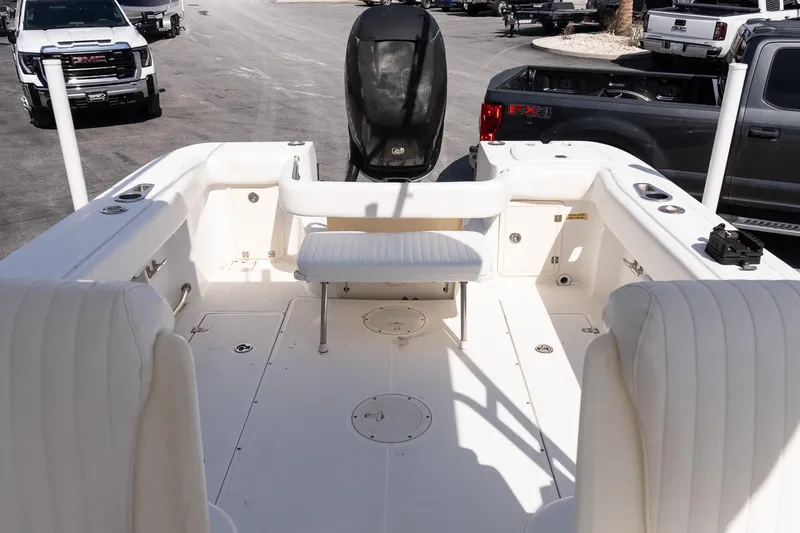 Slide: The Image of 2005 Boston Whaler 235 Conquest boat interior with seating and storage compartments. - 9