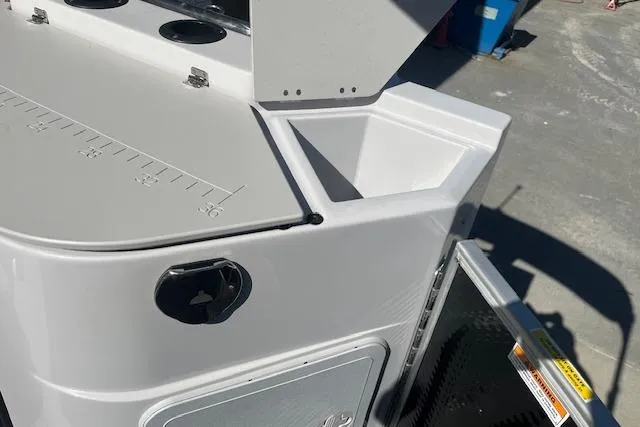 Slide: The Image of 2023 Godfrey Sweetwater 2286 FS boat detail with storage compartment and measuring scale. - 15