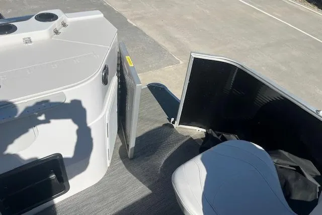 Slide: The Image of 2023 Godfrey Sweetwater 2286 FS boat interior with open door and seating area. - 16