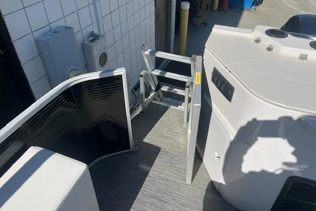 Slide: The Image of 2023 Godfrey Sweetwater 2286 FS boat interior with ladder and seating area. - 17