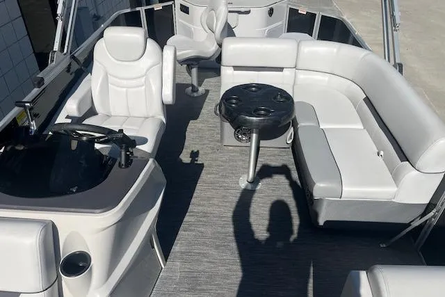 Slide: The Image of 2023 Godfrey Sweetwater 2286 FS pontoon boat interior with plush seating and table. - 7