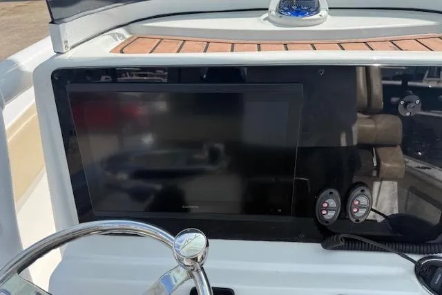 Slide: The Image of Dashboard of 2022 Tidewater 2700 Carolina Bay boat with Garmin display and controls. - 14
