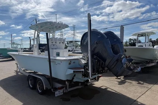 Slide: The Image of 2022 Tidewater 2700 Carolina Bay boat on trailer with dual outboard motors. - 3