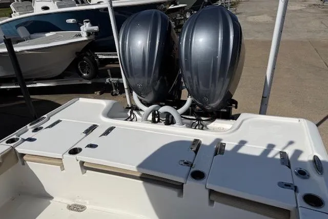 Slide: The Image of 2022 Tidewater 2700 Carolina Bay boat with dual outboard engines, docked on a sunny day. - 8