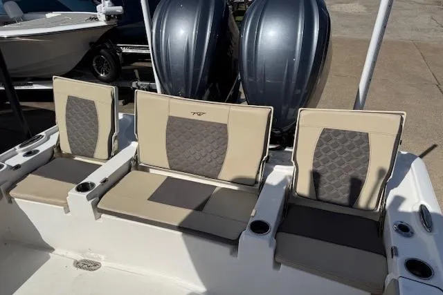 Slide: The Image of 2022 Tidewater 2700 Carolina Bay boat seating with dual engines in the background. - 9