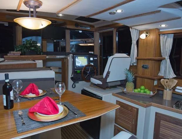 Slide: The Image of Manufacturer Provided Image: 2019 Ranger Tugs R-31 CB interior with dining area, helm station, and kitchen. - 11