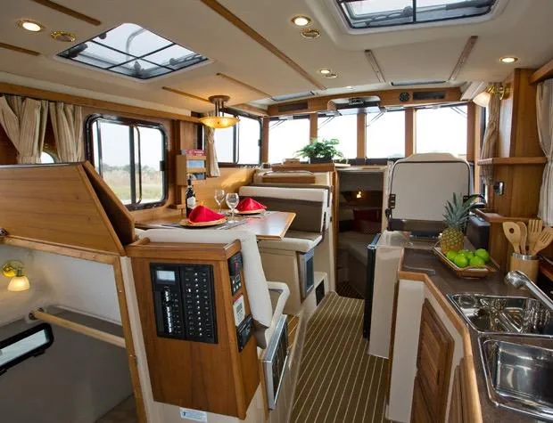 Slide: The Image of Manufacturer Provided Image: Interior of 2019 Ranger Tugs R-31 CB boat with dining area and kitchen. - 12
