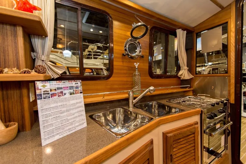 Slide: The Image of Manufacturer Provided Image: 2019 Ranger Tugs R-31 CB kitchen area with dual sinks and stove. - 14