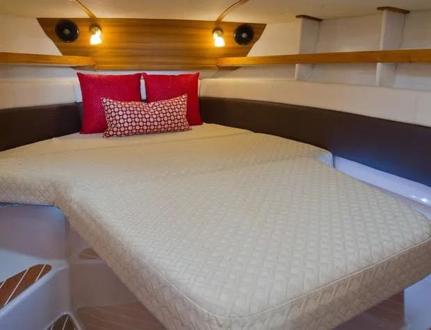 Slide: The Image of Manufacturer Provided Image: 2019 Ranger Tugs R-31 CB cozy cabin bed with red accent pillows. - 16