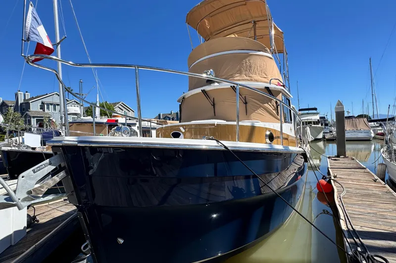 Slide: The Image of 2019 Ranger Tugs R-31 CB docked at marina under clear blue sky. - 19