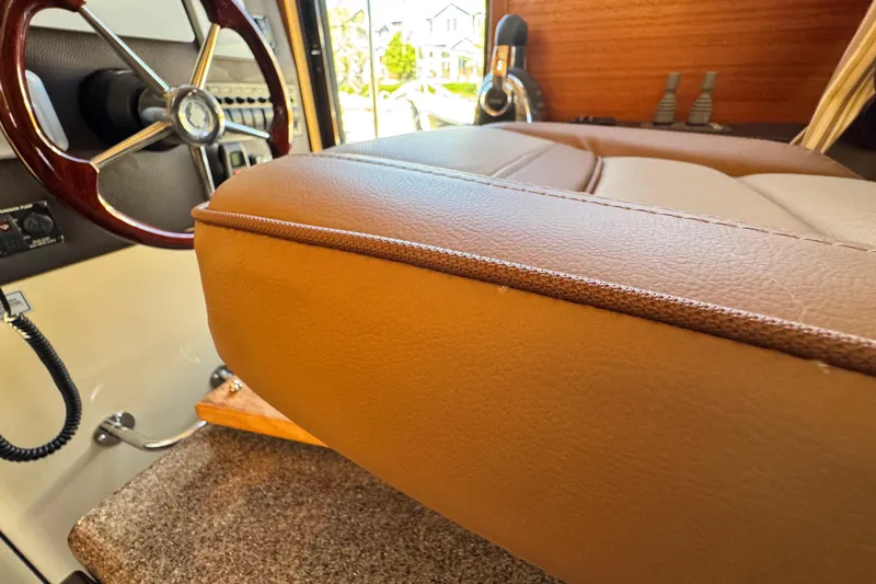 Slide: The Image of Interior of 2019 Ranger Tugs R-31 CB with leather seating and wooden steering wheel. - 22