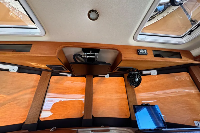 Slide: The Image of Interior view of 2019 Ranger Tugs R-31 CB with wood paneling and modern equipment. - 23