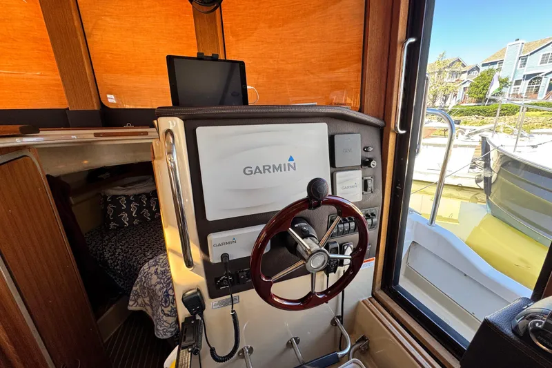 Slide: The Image of 2019 Ranger Tugs R-31 CB helm with Garmin navigation system and wooden steering wheel. - 25