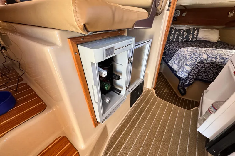 Slide: The Image of 2019 Ranger Tugs R-31 CB interior with mini fridge and cozy cabin bed. - 33
