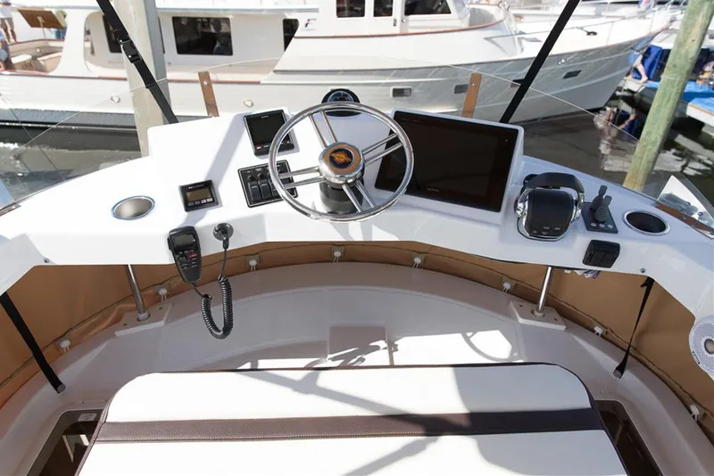 Slide: The Image of Manufacturer Provided Image: 2019 Ranger Tugs R-31 CB helm station with steering wheel and navigation equipment. - 7
