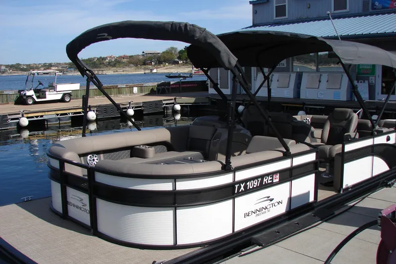 Slide: The Image of 2019 Bennington SX 25 SCWXP pontoon boat docked at marina with canopy. - 13