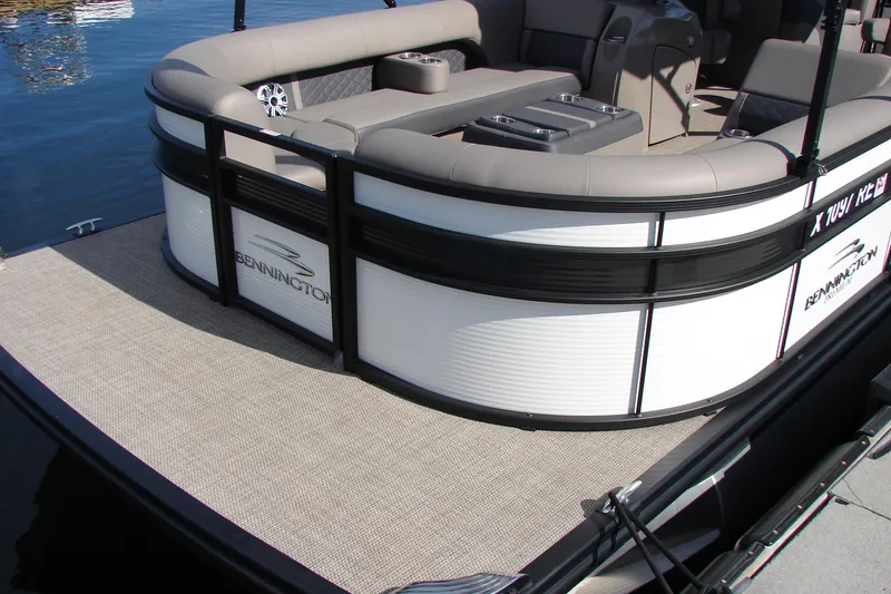 Slide: The Image of 2019 Bennington SX 25 SCWXP pontoon boat with beige seating on calm water. - 18