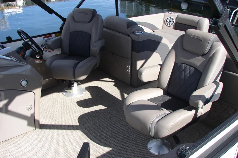 Slide: The Image of Interior of 2019 Bennington SX 25 SCWXP boat with plush seating and steering wheel. - 21