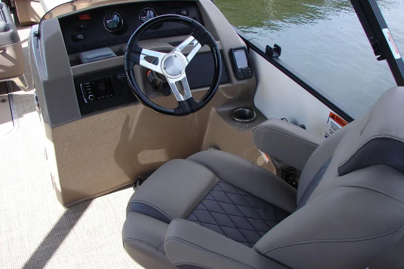 Slide: The Image of 2019 Bennington SX 25 SCWXP boat helm with steering wheel and comfortable seating. - 23