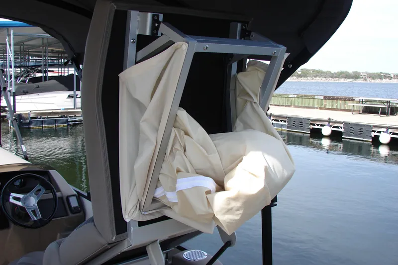 Slide: The Image of 2019 Bennington SX 25 SCWXP boat with folded canopy near a dock. - 33