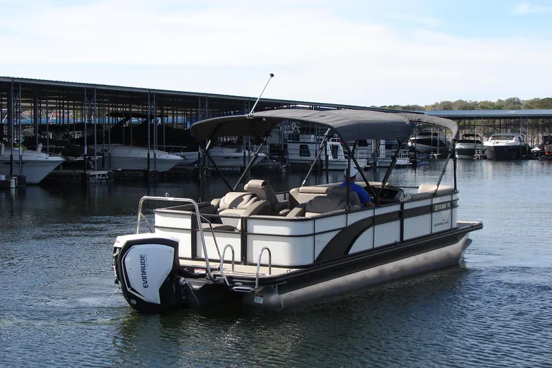 Slide: The Image of 2019 Bennington SX 25 SCWXP pontoon boat cruising near marina docks. - 5